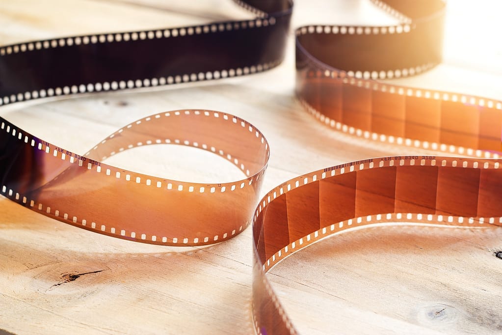 Movie film strips on wooden background
